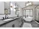 Bright primary bathroom with dual sinks, soaking tub, walk-in shower and modern fixtures at 9423 Man O War Rd, Fort Mill, SC 29707