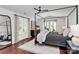 Primary bedroom featuring a four-poster bed, hardwood floors, and french doors to the deck at 9423 Man O War Rd, Fort Mill, SC 29707