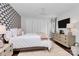 Bedroom showcasing a patterned accent wall, a large window, and hardwood floors at 9423 Man O War Rd, Fort Mill, SC 29707