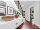 Inviting foyer with hardwood floors, white console table, and staircase with black metal railing at 9423 Man O War Rd, Fort Mill, SC 29707