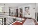 Upstairs hallway with hardwood floors, black metal railings, and view of a bedroom at 9423 Man O War Rd, Fort Mill, SC 29707
