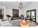 Elegant living room showcasing a stone fireplace, stylish seating, and access to an outdoor patio at 9423 Man O War Rd, Fort Mill, SC 29707