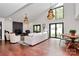 Expansive living room with hardwood floors, large windows, stone fireplace, and views to the backyard at 9423 Man O War Rd, Fort Mill, SC 29707