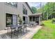 Outdoor patio with dining set, lounge chairs, and a landscaped backyard, ideal for relaxation and entertaining at 9423 Man O War Rd, Fort Mill, SC 29707