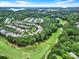 Aerial shot featuring the community, golf course, lush greenery, and a glimpse of a lake at 964 Knob Creek Ln, Fort Mill, SC 29708