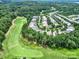 Aerial view showcasing the community, golf course, and surrounding wooded area at 964 Knob Creek Ln, Fort Mill, SC 29708