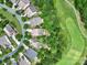 Aerial view featuring homes in a neighborhood adjacent to a golf course, and surrounded by lush greenery at 964 Knob Creek Ln, Fort Mill, SC 29708