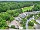 Scenic aerial view of several homes with lush landscaping and a golf course in the distance at 964 Knob Creek Ln, Fort Mill, SC 29708