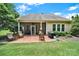 Inviting backyard with a brick patio, lush greenery, and scenic landscaping at 964 Knob Creek Ln, Fort Mill, SC 29708