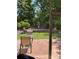 View from the screened porch to the peaceful backyard with a brick patio and a lovely water feature at 964 Knob Creek Ln, Fort Mill, SC 29708