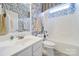 Charming bathroom featuring floral wallpaper, white vanity, and a shower-tub combination at 964 Knob Creek Ln, Fort Mill, SC 29708