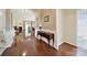 Elegant entryway boasting hardwood floors, decorative console table, and arched doorways leading to the home's inviting spaces at 964 Knob Creek Ln, Fort Mill, SC 29708