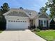 Charming single-Gathering home with a two-car garage, manicured lawn, and an American flag displayed near the entrance at 964 Knob Creek Ln, Fort Mill, SC 29708