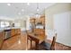 Bright kitchen featuring stainless steel appliances, a breakfast table and hardwood floors, perfect for a modern lifestyle at 964 Knob Creek Ln, Fort Mill, SC 29708