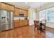 Bright kitchen featuring stainless steel appliances, breakfast table, and hardwood floors for a modern aesthetic at 964 Knob Creek Ln, Fort Mill, SC 29708
