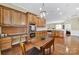 Well-equipped kitchen featuring stainless steel appliances, wood cabinetry, hardwood floors and modern lighting fixtures at 964 Knob Creek Ln, Fort Mill, SC 29708