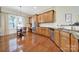 Well-lit kitchen features stainless steel appliances, wood cabinetry, and hardwood floors for a modern aesthetic at 964 Knob Creek Ln, Fort Mill, SC 29708
