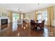 Open-concept living room with fireplace, hardwood floors, and access to the outdoor patio at 964 Knob Creek Ln, Fort Mill, SC 29708