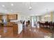 Open-concept living space featuring hardwood floors, a modern kitchen, cozy breakfast nook, and access to the outdoor patio at 964 Knob Creek Ln, Fort Mill, SC 29708