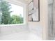Bright bathroom features a soaking tub with a marble backsplash and a large window with a wooded view at 9858 Jack Nicklaus Dr # 897, Lancaster, SC 29720