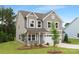 Attractive two-story home with gray siding, a manicured lawn, and an attached two-car garage at 9858 Jack Nicklaus Dr # 897, Lancaster, SC 29720