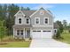 Charming two-story home with gray siding, white trim, a well-manicured lawn, and an attached two-car garage at 9858 Jack Nicklaus Dr # 897, Lancaster, SC 29720