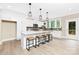 Bright kitchen with white cabinets, a large island with seating, and stainless steel appliances at 9858 Jack Nicklaus Dr # 897, Lancaster, SC 29720