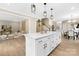 Elegant kitchen with white cabinets, a marble island, and an open layout to the dining and living areas at 9858 Jack Nicklaus Dr # 897, Lancaster, SC 29720