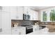 Modern kitchen with white cabinets, stainless steel appliances, and stylish backsplash at 9858 Jack Nicklaus Dr # 897, Lancaster, SC 29720