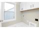 Bright laundry room with white cabinets and a window at 9858 Jack Nicklaus Dr # 897, Lancaster, SC 29720