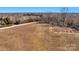 Expansive aerial view of a large land parcel featuring a road, fields, and wooded boundaries, ideal for development at 0000 Milling Rd, Rock Hill, SC 29730