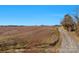 Large plot of land with unpaved road and surrounding trees under a bright blue sky at 0000 Milling Rd, Rock Hill, SC 29730