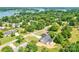 Aerial view of a home nestled among lush trees, with a glimpse of the lake in the background at 102 Starmount Dr, Kings Mountain, NC 28086
