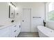 Modern bathroom with double vanity, soaking tub, and sleek black fixtures at 102 Starmount Dr, Kings Mountain, NC 28086
