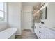 Bright bathroom featuring a modern tub, sleek vanity, and glass enclosed shower at 102 Starmount Dr, Kings Mountain, NC 28086