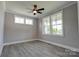 Bright bedroom with large windows, a ceiling fan, and modern laminate flooring at 102 Starmount Dr, Kings Mountain, NC 28086