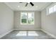 Bright bedroom with large windows, ceiling fan, and modern gray flooring at 102 Starmount Dr, Kings Mountain, NC 28086