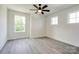 Bright bedroom with ceiling fan, gray laminate floors and large windows at 102 Starmount Dr, Kings Mountain, NC 28086