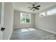 Bedroom with two windows, grey walls, ceiling fan, and laminate flooring at 102 Starmount Dr, Kings Mountain, NC 28086