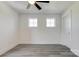 Bedroom with ceiling fan, laminate floors, two bright windows, and a closet at 102 Starmount Dr, Kings Mountain, NC 28086