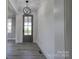 Foyer showcasing a stylish gray front door with glass paneling and modern light fixture at 102 Starmount Dr, Kings Mountain, NC 28086