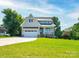 Charming two-story home featuring an attached two-car garage and landscaped front yard at 102 Starmount Dr, Kings Mountain, NC 28086