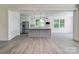 Modern kitchen featuring white cabinets, gray island, and stainless steel appliances at 102 Starmount Dr, Kings Mountain, NC 28086