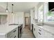 Modern kitchen with white cabinets, quartz countertops, and stainless steel appliances at 102 Starmount Dr, Kings Mountain, NC 28086