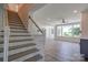 Bright living room with large windows, hardwood floors, and open staircase at 102 Starmount Dr, Kings Mountain, NC 28086