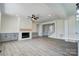 Bright living room with fireplace, custom cabinets, open floor plan, and modern flooring at 102 Starmount Dr, Kings Mountain, NC 28086