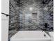 Modern shower with beautiful dark tile work and rainfall shower head at 102 Starmount Dr, Kings Mountain, NC 28086