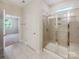 Bathroom features a glass-enclosed shower and modern tile flooring at 103 Margo Ln, Statesville, NC 28677