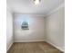 Sunlit bedroom with neutral walls, plush carpeting, and a large window at 103 Margo Ln, Statesville, NC 28677