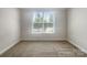 Well-lit bedroom featuring plush carpeting and a large window at 103 Margo Ln, Statesville, NC 28677